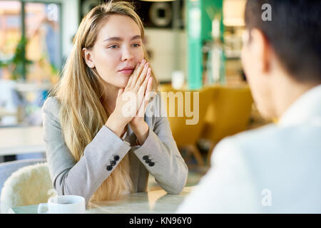 Blonde Young Businesswoman in Cafe
