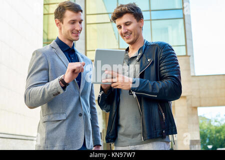 Two  Young Men Using Digital Tablet Stock Photo