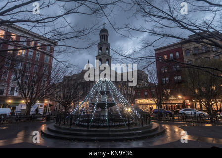 New York, NY, USA, Christmas lights on the fountain in Father Demo Square with Our Lady of Pompeii Catholic Church in the background CREDIT ©Stacy Walsh Rosenstock/Alamy Stock Photo