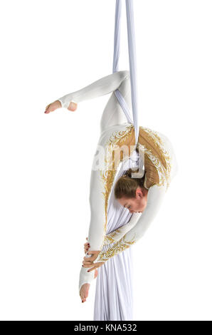 Pretty woman - aerialist performing aerial tricks on aerial silks. Studio shooting on a white background. Stock Photo