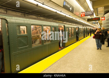 New York, NY - December 10, 2017: New Yorkers and tourists ride Holiday Nostalgia Train on vintage subway cars courtesy of Metropolitan Transit Authority Stock Photo