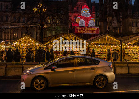 Night time stalls and Manchester Town Hall at Manchester Christmas Markets Around The City, Manchester, England, UK Stock Photo