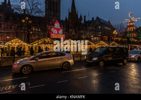 Night time stalls and Manchester Town Hall at Manchester Christmas Markets Around The City, Manchester, England, UK Stock Photo