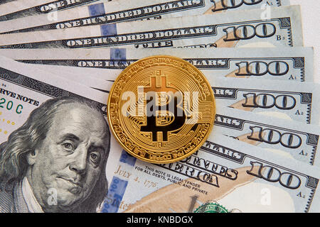 One Bitcoin on banknotes. Closeup, Macro shot. Buying bitcoins for dollars. Selling gold bitcoin. Profit from trading on the stock exchange cryptocurr Stock Photo