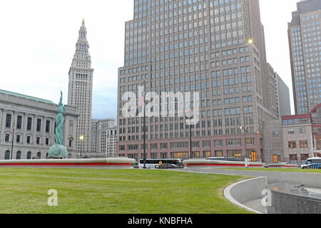 The outdoor grassy 'mall' area in downtown Cleveland, Ohio, flanked by iconic landmarks including the Fountain of Eternal Life statue on a fall day. Stock Photo