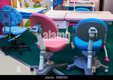 Children's chairs on wheels and desks in the store Stock Photo