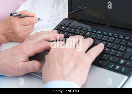 hands typing on the keyboard Stock Photo