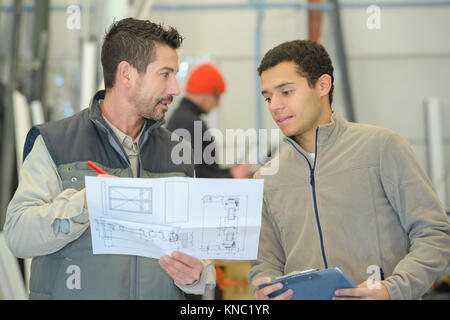 male engineer and worker checking indoor building construction site Stock Photo