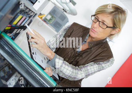 woman on printer maintenance Stock Photo