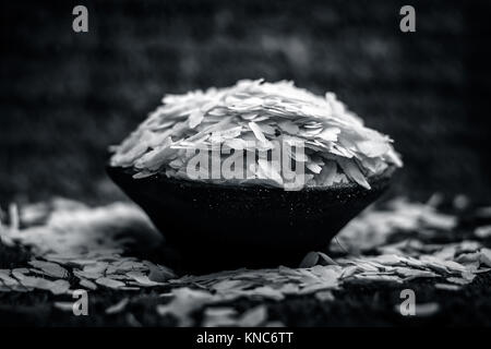 Oryza sativa,Puffed rice in a clay bowl on a gunny background. Stock Photo