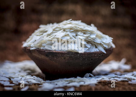 Oryza sativa,Puffed rice in a clay bowl on a gunny background. Stock Photo