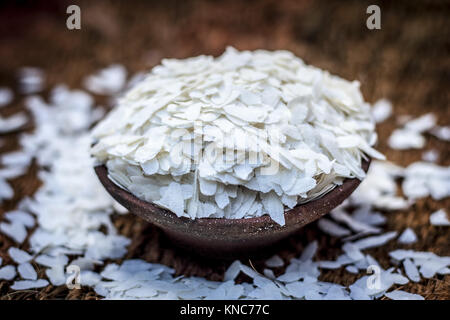 Oryza sativa,Puffed rice in a clay bowl on a gunny background. Stock Photo