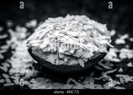 Oryza sativa,Puffed rice in a clay bowl on a gunny background. Stock Photo