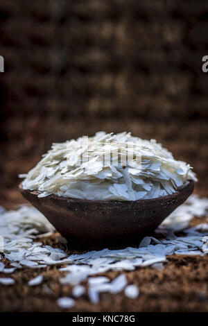 Oryza sativa,Puffed rice in a clay bowl on a gunny background. Stock Photo