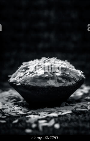 Oryza sativa,Puffed rice in a clay bowl on a gunny background. Stock Photo