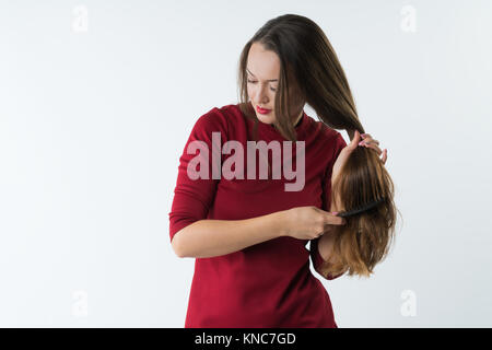 Beautiful woman combs her healthy hair. Combing healthy long straight ...