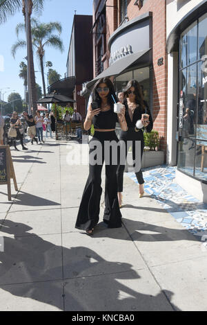 BEVERLY HILLS, CA - JULY 28: Kylie Jenner, 17, continues to flaunt new band on wedding finger that may be from beau Tyga, 25 as seen here on a Greek yogurt run with sister Kendall Jenner on July 28, 2015 in Beverly Hills, California.  People:  Kylie Jenner, Kendall Jenner Stock Photo