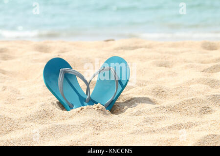Blue flip flop sandals on beach Stock Photo
