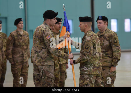 ANSBACH, Germany – Col. Kenneth Cole, 12th Combat Aviation Brigade (CAB) Commander hands over the Company’s Colors from the Headquarters and Headquarters Company (HHC), 12th CAB Commander Cpt. William McGinnis to the incoming HHC, 12th CAB Commander Cpt. Charles Flanagan. Katterbach Army Airfield, Dec. 6, 2017 (U.S. Army Stock Photo