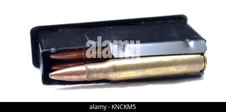 A fully loaded rifle magazine laying on it's side on a white background Stock Photo