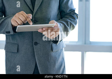 man touch tablet, laptop connecting wifi technology business people workspace Stock Photo