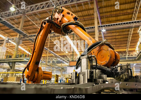 Robot arms handle tool keep automotive part to spot machine in car factory Stock Photo