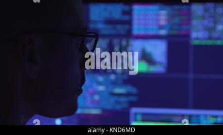 Computer programmer in glasses working on a computer Stock Photo