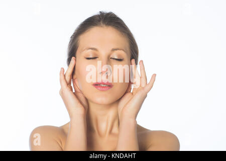 Beautiful young blond woman massaging temples against a white background Stock Photo