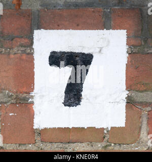 Painted house number seven sign on wall Stock Photo