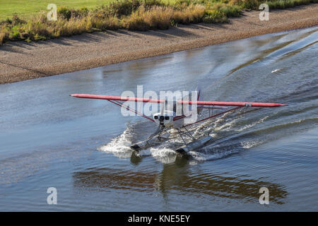 Floatplane landing on the Chena River in the fall (autumn) in Fairbanks, Alaska, USA Stock Photo