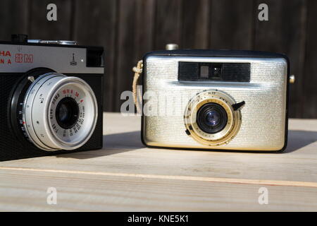 BOROTIN, CZECH REPUBLIC - MARCH 25: Smena 8M and Penti I old vintage golden cameras on wooden background on March 25, 2017 in Borotin, Czech Republic. Stock Photo