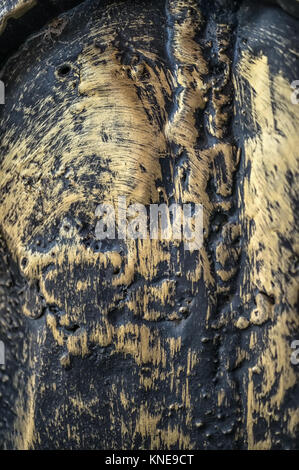 Gold metal texture background with wrought-iron picture is not in focus. Close-up. The vertical frame. . Stock Photo