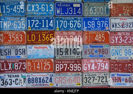 Red Oak, Missouri - July 19, 2017: Various old American license plates on wall. License plates are from various American states. Stock Photo