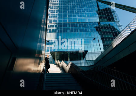 Mature businessman outdoors, standing on steps, low angle view Stock Photo