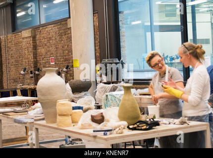 Colleagues in art studio making pottery Stock Photo