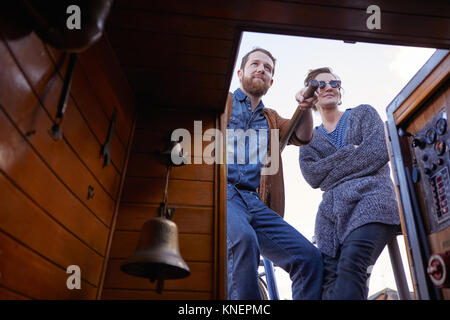 Couple steering canal boat Stock Photo