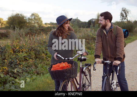 Couple enjoying cycling on marshes Stock Photo
