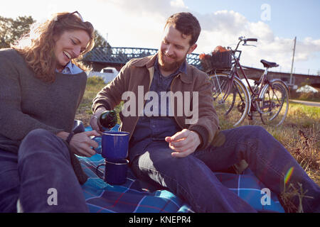 Couple enjoying coffee break on marshes Stock Photo