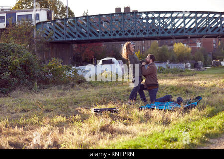 Man proposing to woman on marshes Stock Photo