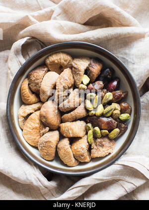 Dried fruit and mixed nuts in bowl, close-up Stock Photo