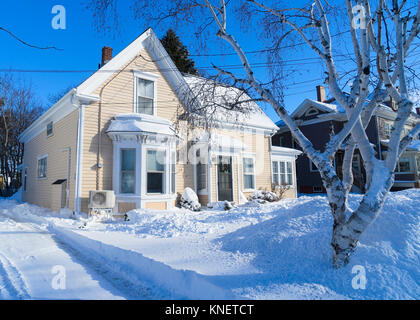 Older traditional house in wintertime in a North American neighborhood. Stock Photo