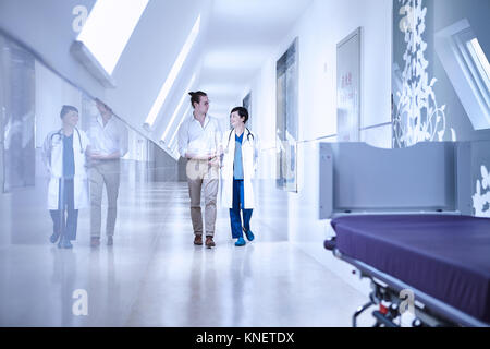 Doctors walking in hospital corridor Stock Photo