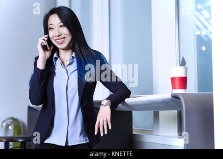 Businesswoman using smartphone, making telephone call, smiling Stock Photo