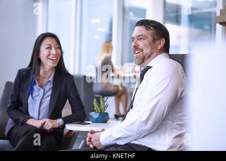 Colleagues in office laughing Stock Photo