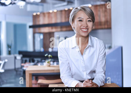 Portrait of short haired woman looking at camera smiling Stock Photo