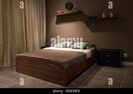 Large double bed in the bedroom Stock Photo
