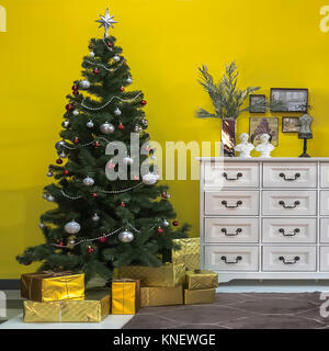 Beautiful Christmas tree with gift boxes in interior of living room Stock Photo
