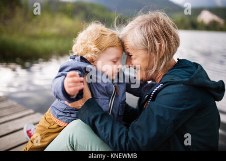 Senior woman with little boy at the lake. Stock Photo