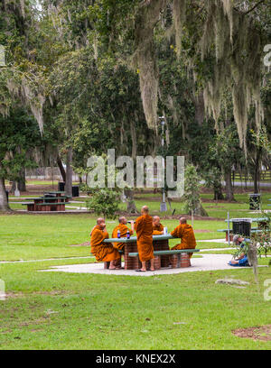Group of Buddhist monks taking a travel break in picnic area along 1-75 in Georgia.
