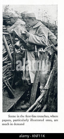 The caption for this photo that dates to between 1914 and 1917 (time of the First World War) reads: Scene in the first-line trenches, where papers, particularly illustrated ones, are much in demand. Stock Photo
